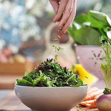 Sprinkle herbs on a salad