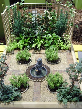 This table-top miniature garden in a box takes a formal turn - complete with a statue in the middle.